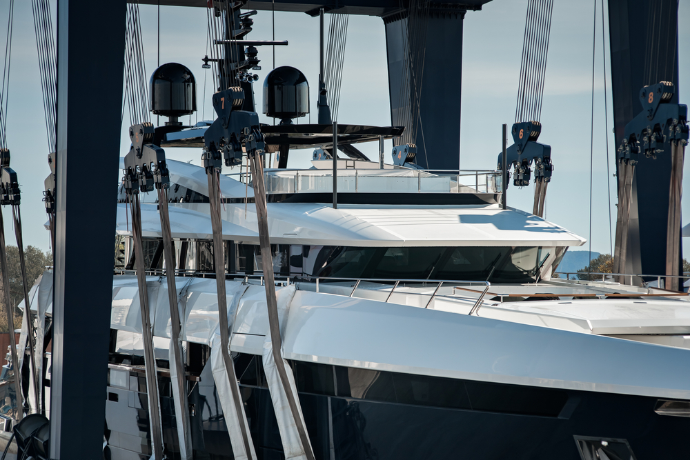 Super,Yacht,Hauled,Out,In,Shipyard,,Being,Lifted,By,Industrial