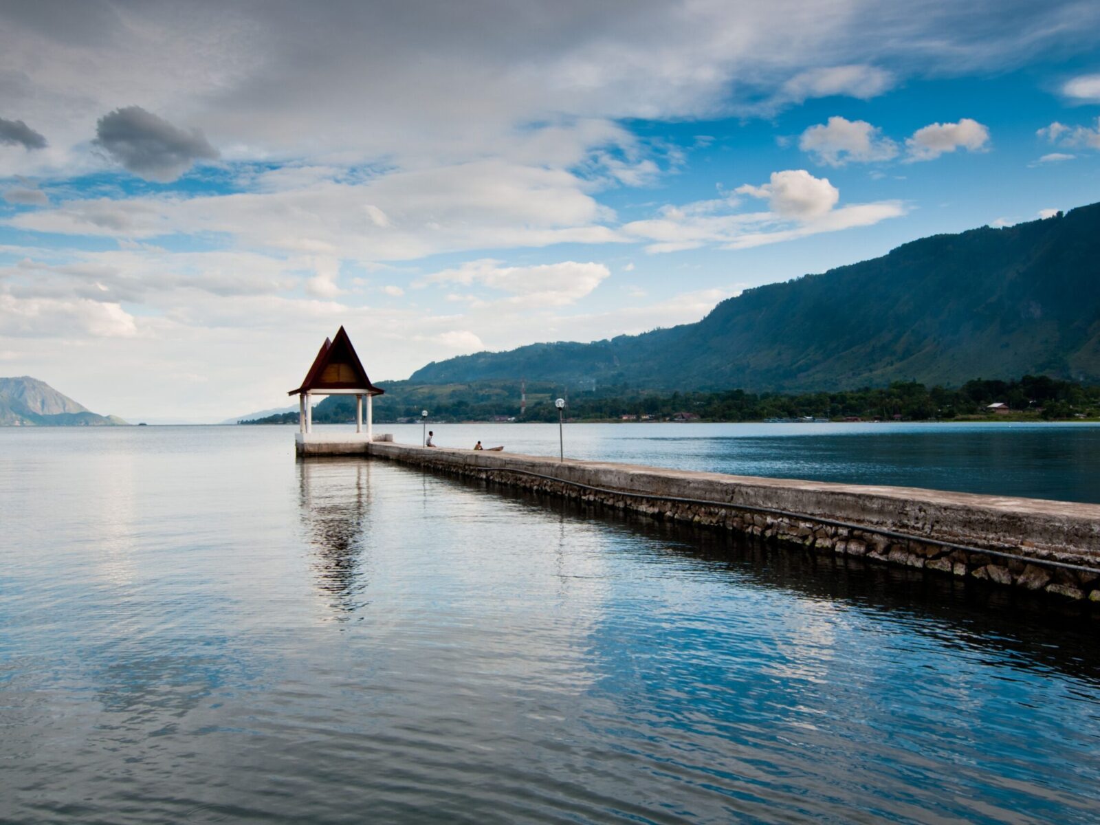 A,Scenic,View,Of,A,Pier,With,Mountains,In,The