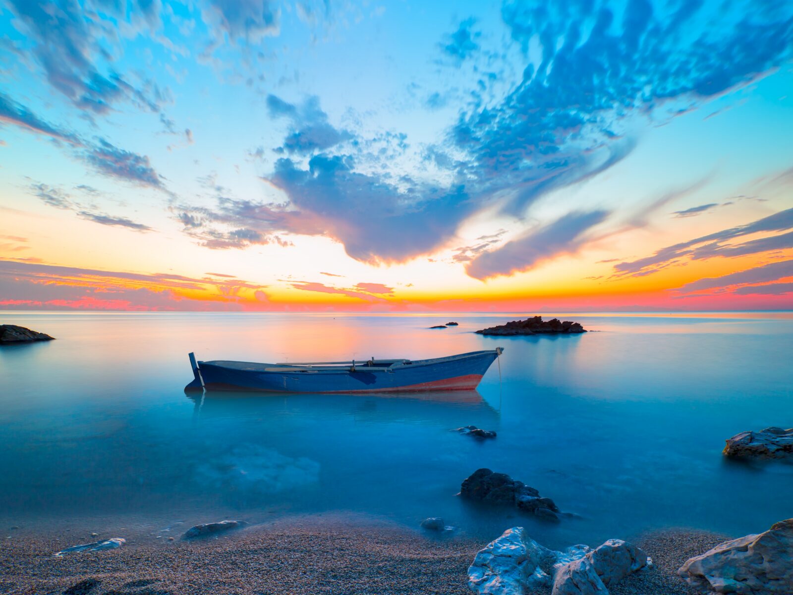 Long,Exposure,Photo,Of,Sunset,On,A,Rocky,Beach,