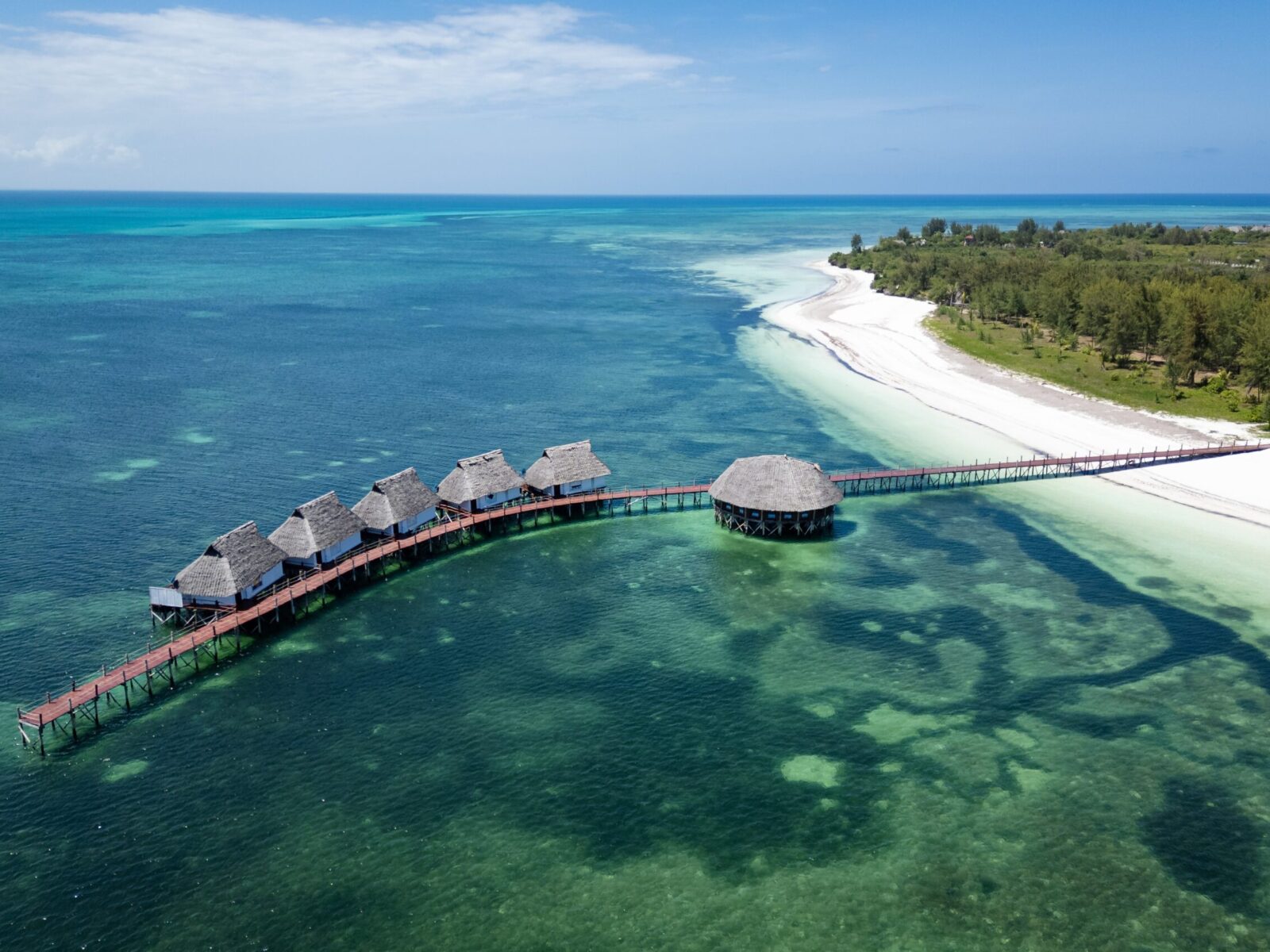 Aerial,View,Of,Luxury,Overwater,Bungalows,With,Thatched,Roofs,And